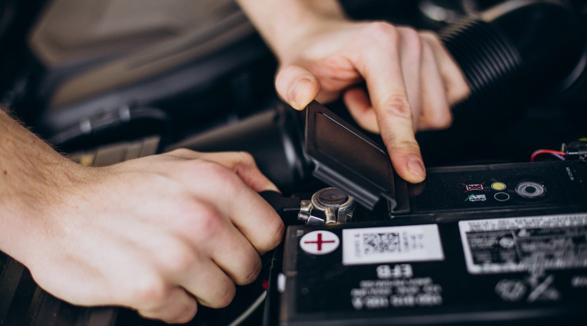 Automotive battery installed in a car engine bay